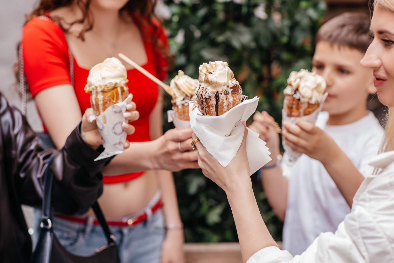 Friends raising ice cream treats together